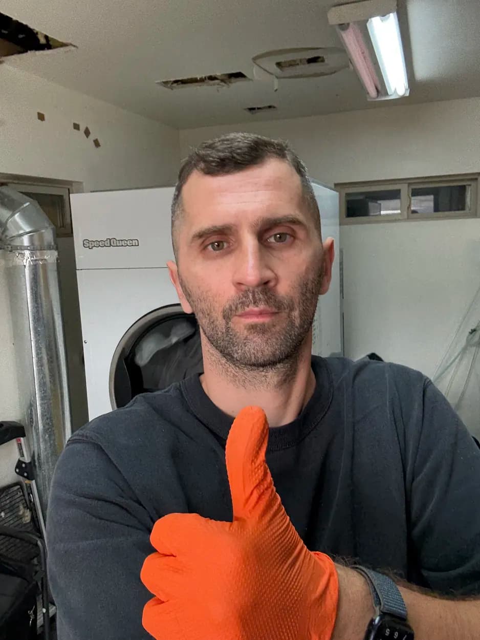 Yurii, owner and lead technician, during a Speed Queen washer repair