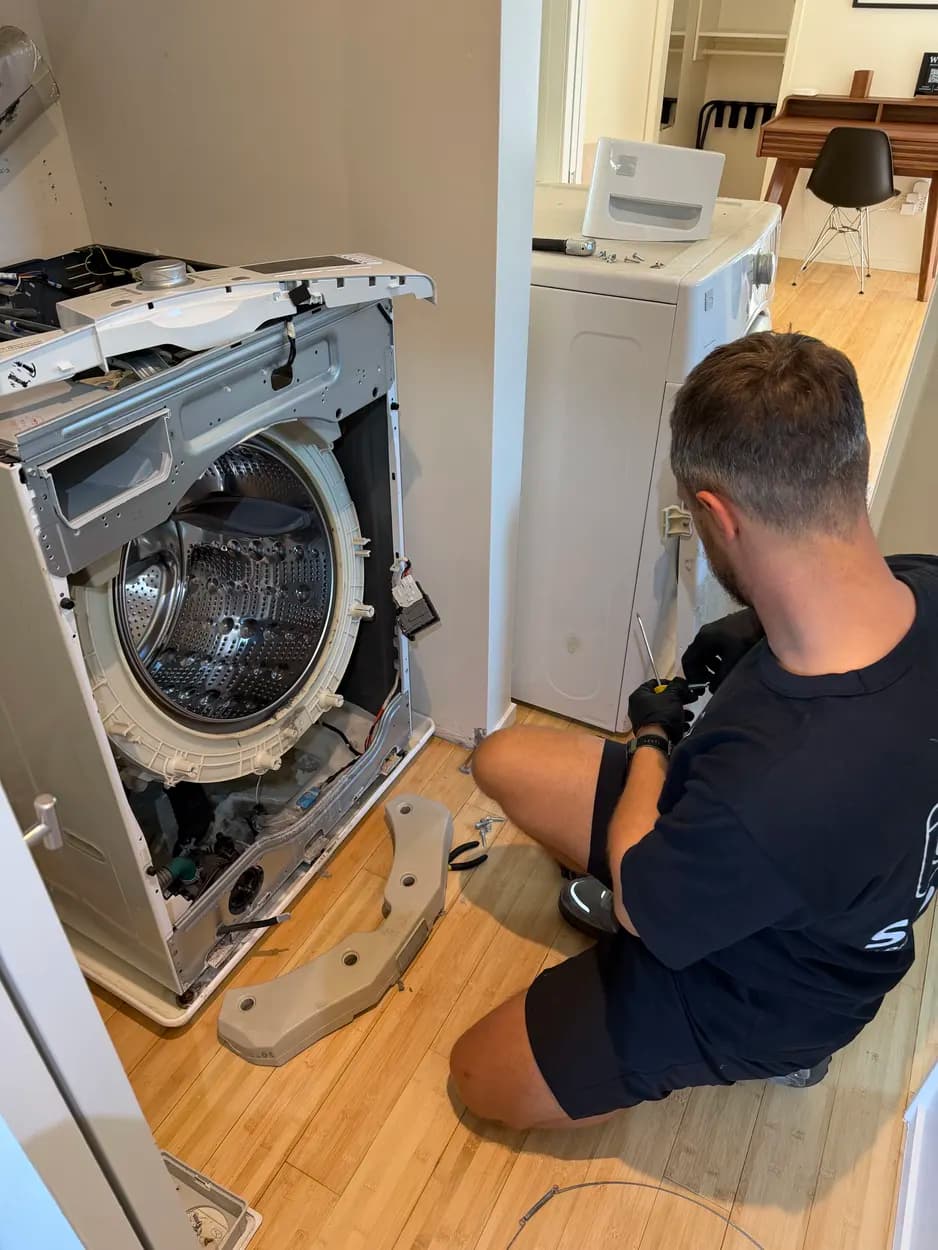 Servicing a top-load washer at a customer's home in Escondido