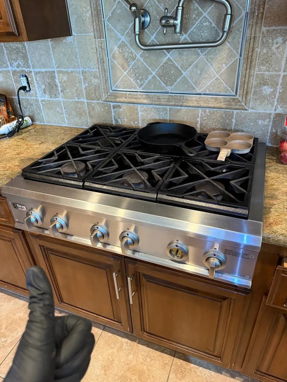 Servicing a gas cooktop on a house call in Escondido