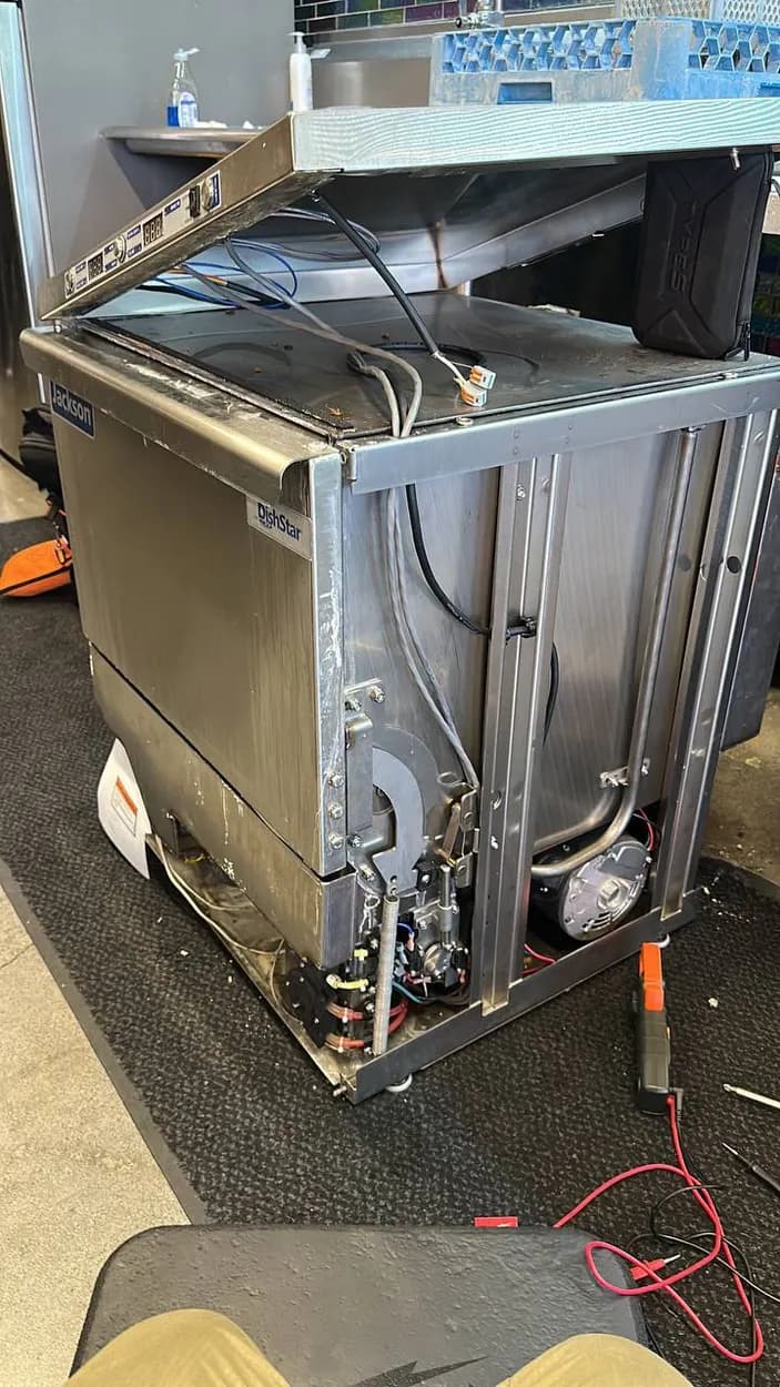 Commercial dishwasher pulled out for repair at a North County business