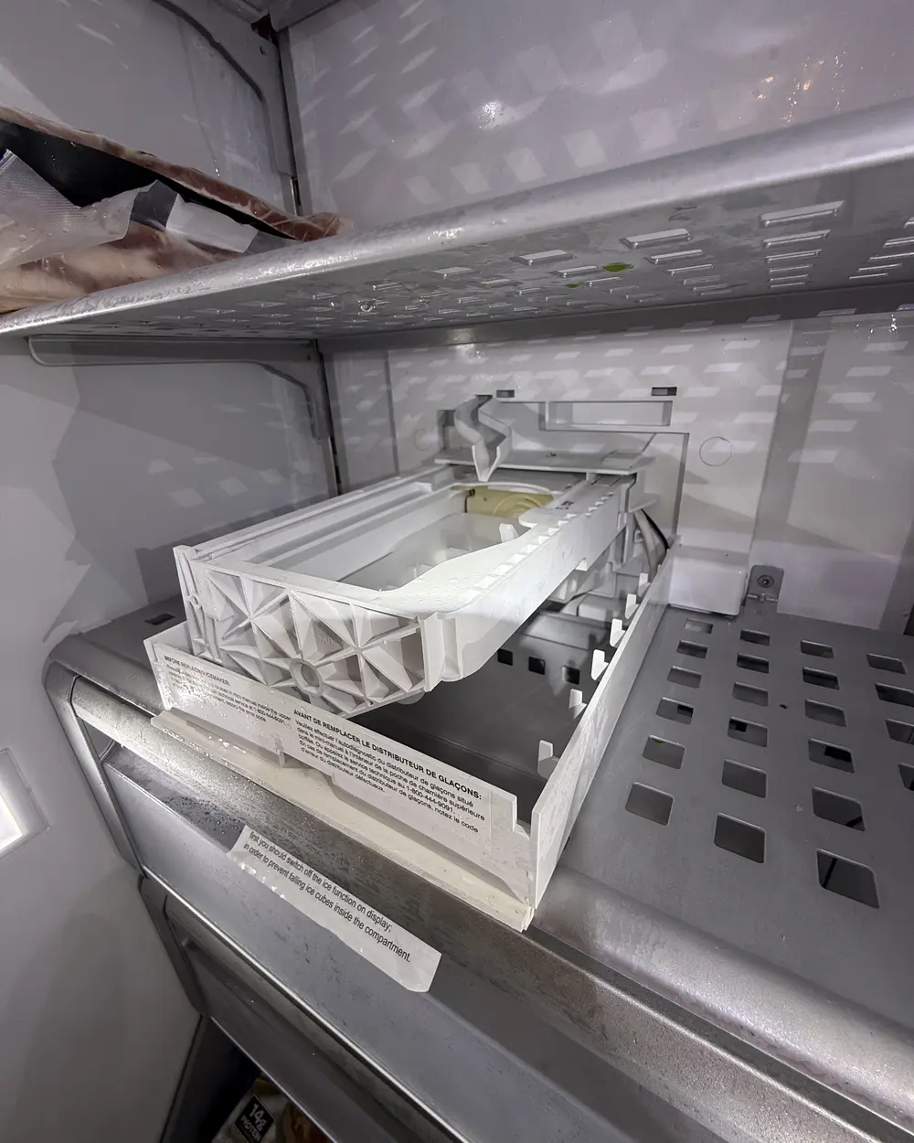 Inside a freezer compartment during an ice-maker repair in Escondido