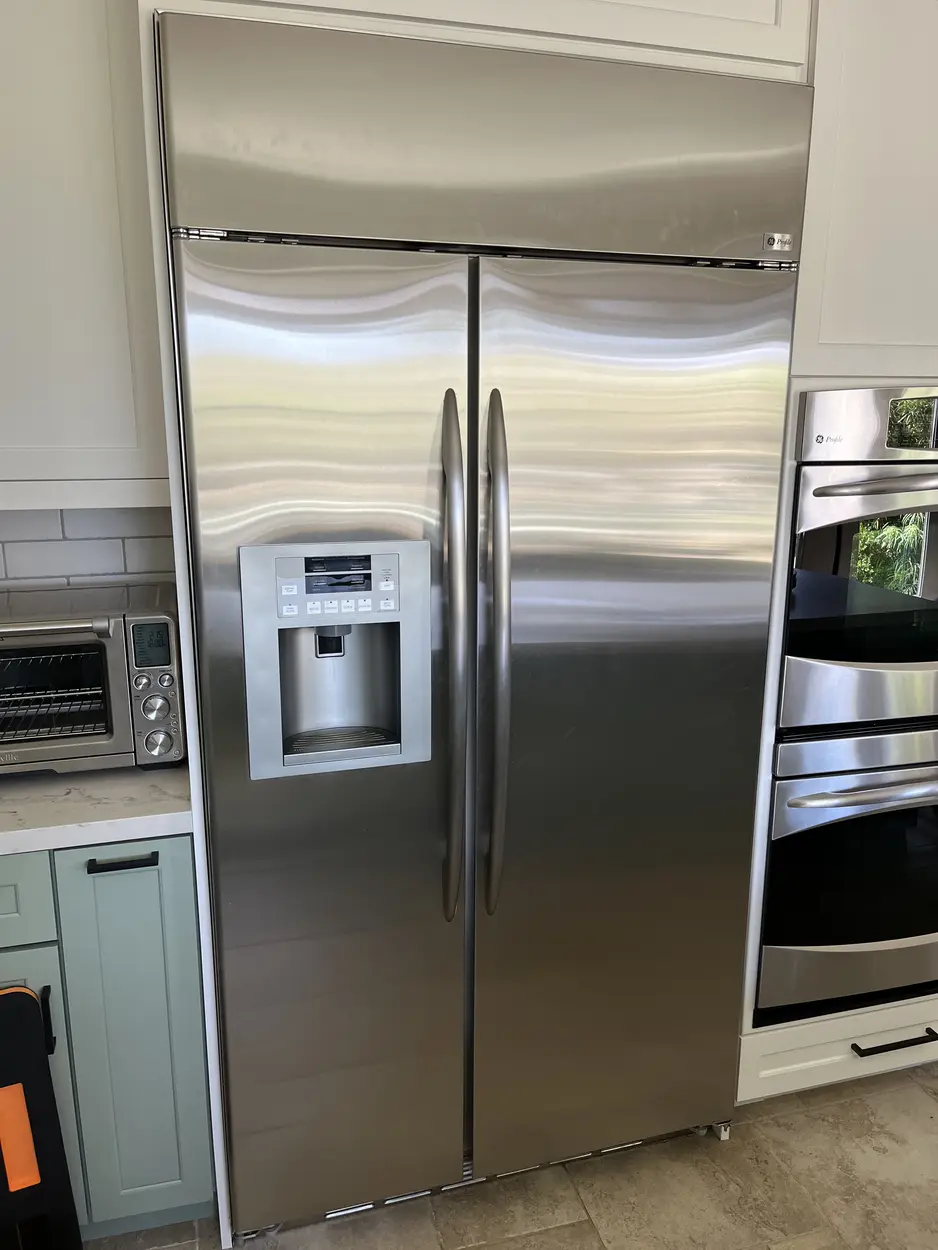 GE side-by-side refrigerator serviced in a San Marcos kitchen