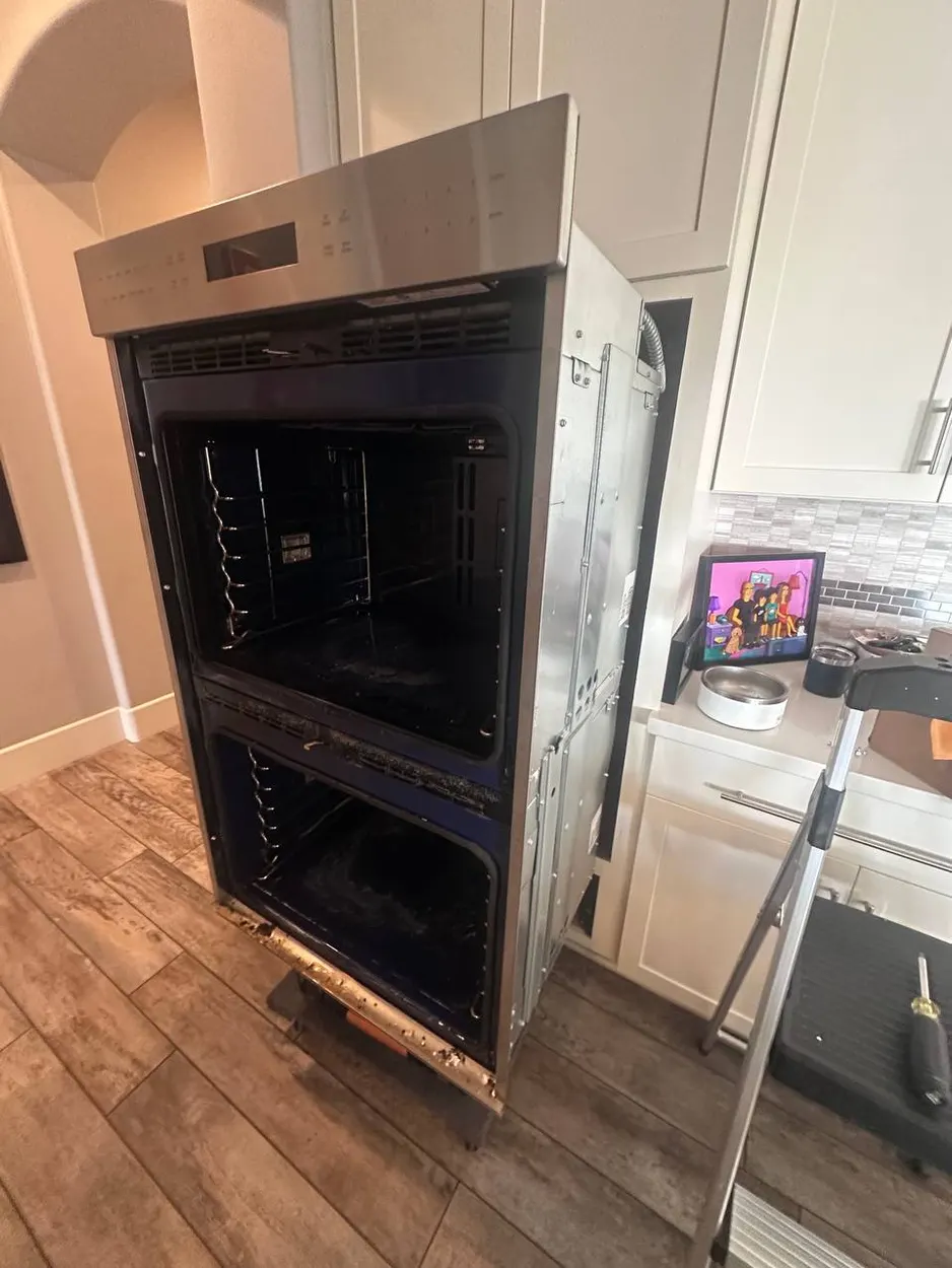 Fitting a double wall oven into its cabinet on a North County install