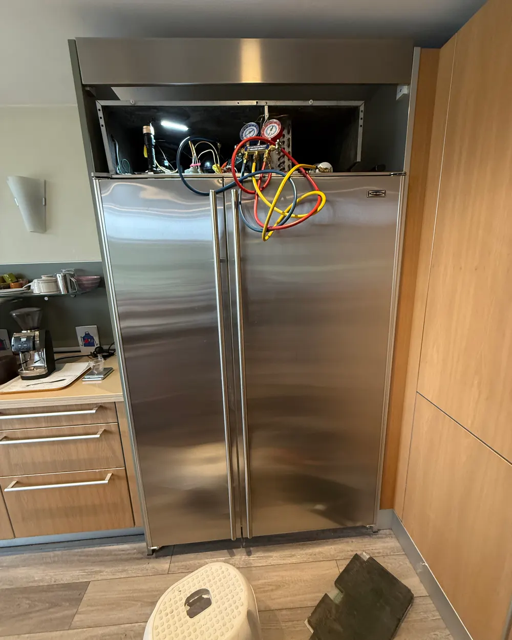 Checking refrigerant pressures on an open French-door refrigerator in Escondido