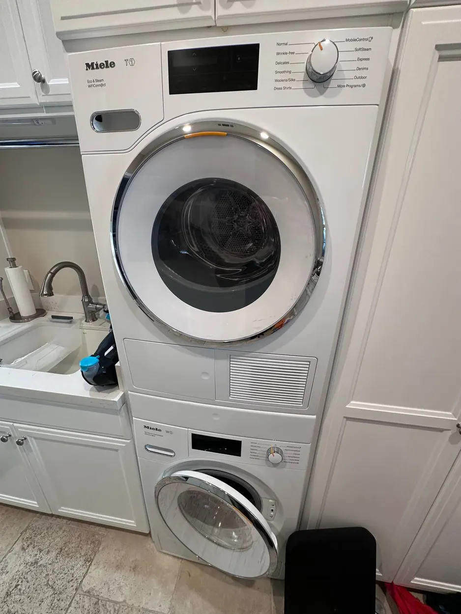 Stacked washer and dryer serviced in an Escondido laundry room